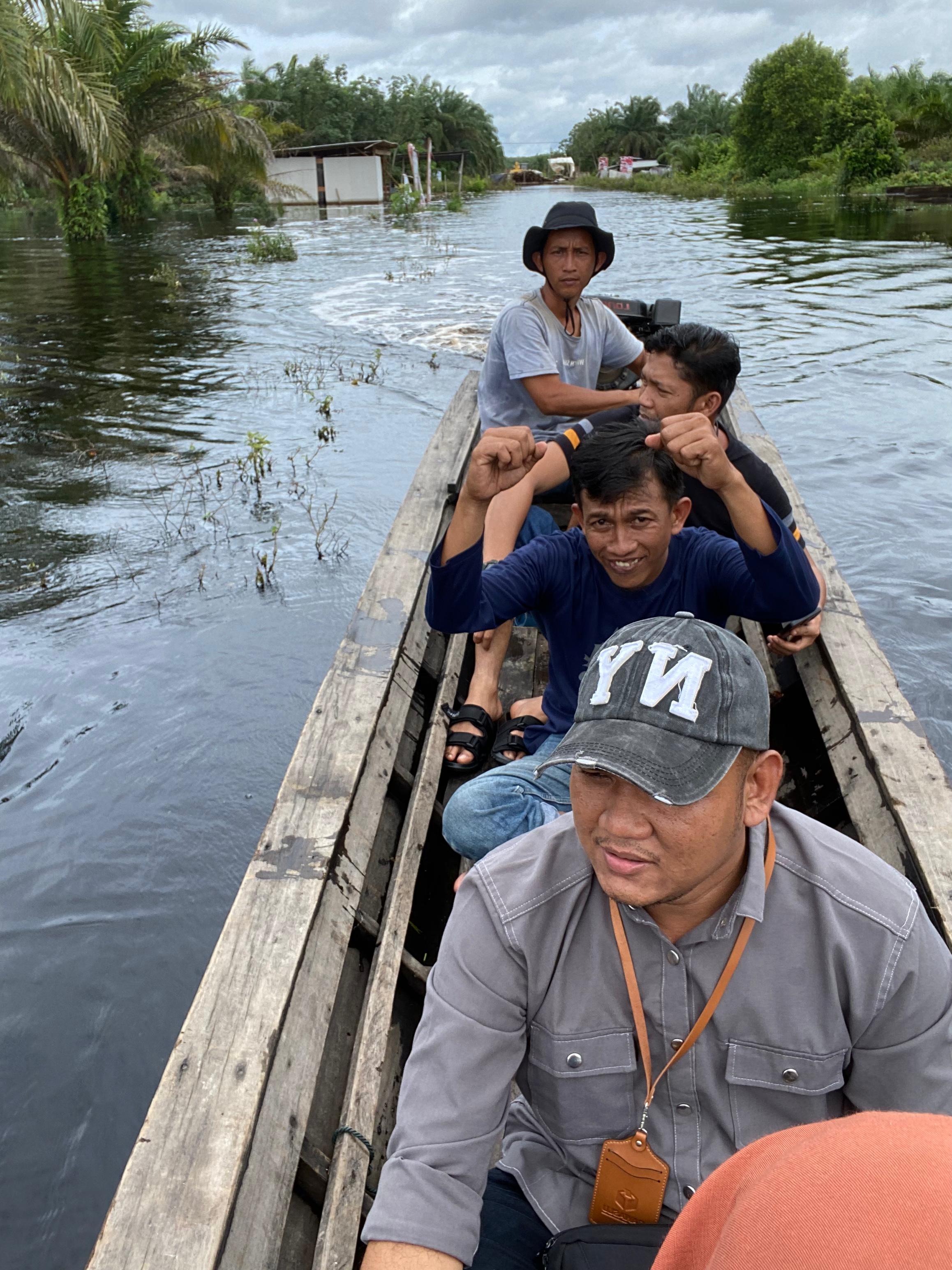 Anggota Bawaslu Bnegkalis, Ardi Suprianto (depan) saat meninjau TPS terdampak banjir Di Desa Sungai Linau, Kecamatan Siak Kecil.